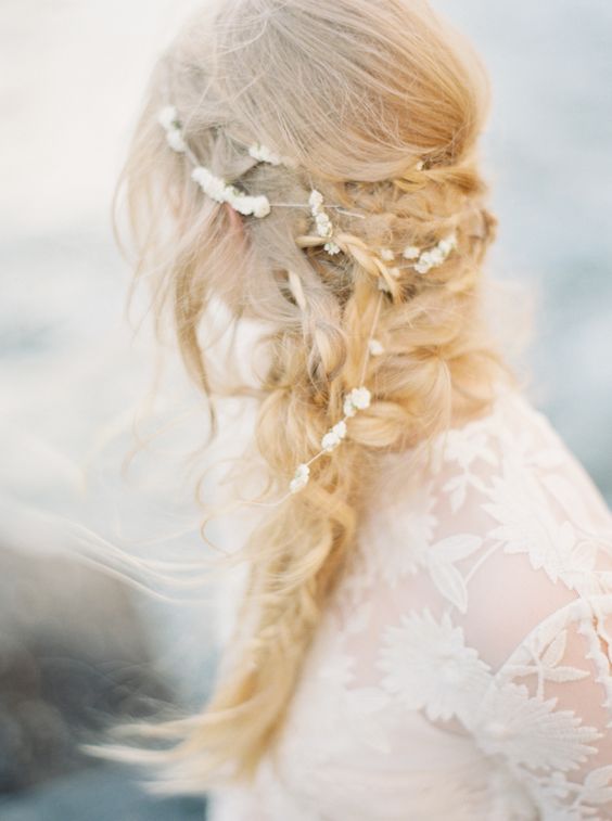 a messy braid with some locks down and much volume for a boho beahc bride
