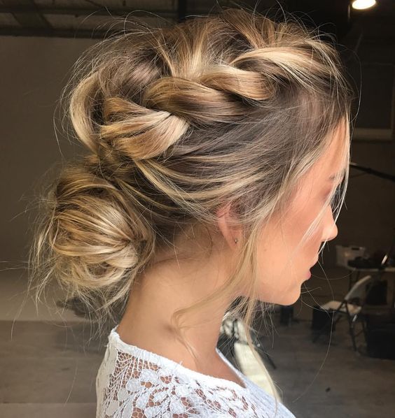 a messy updo with a loose halo braid on top and some locks down for a boho bride