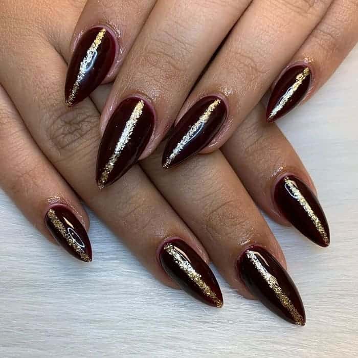 maroon and gold stiletto nails