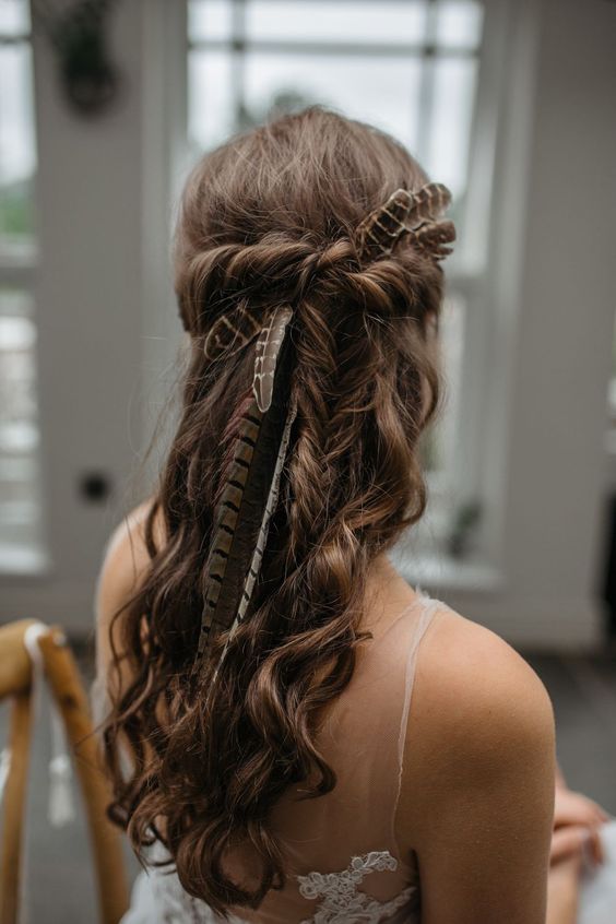 loose waves with a braided halo are classics for any boho bride, such a hairstyle may be spruced up with greenery and blooms