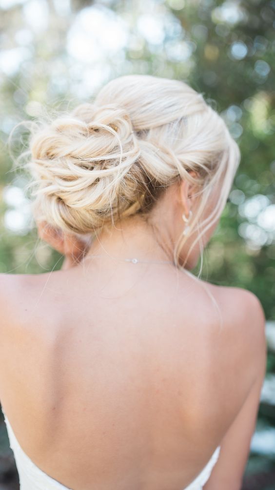 a messy braided updo with some locks down looks cool and boho chic