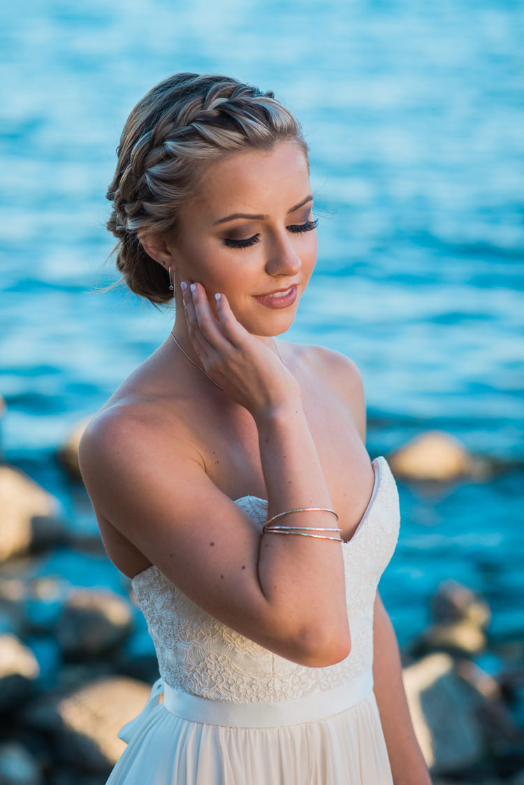 a wavy and messy updo with curls down and a sparkling rhinestone headpiece