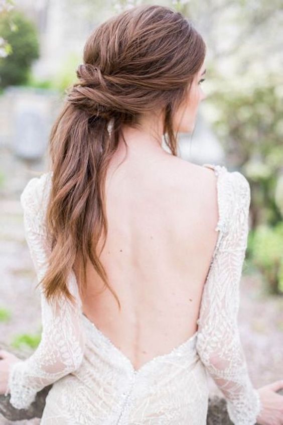 an effortlessly chic textural ponytail with several twists looks very soft and romantic