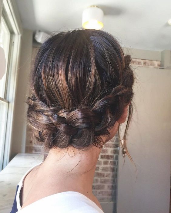 a large sided braided updo with a low bun and some locks down is super chic and refined