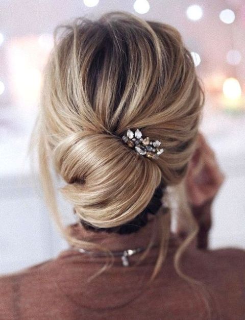 a very messy updo with twists and locks down for short hair looks very chic