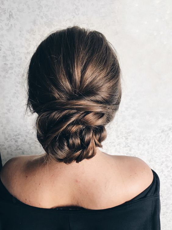 a chic tight low bun with twists will last all day long and will fit even the most formal style