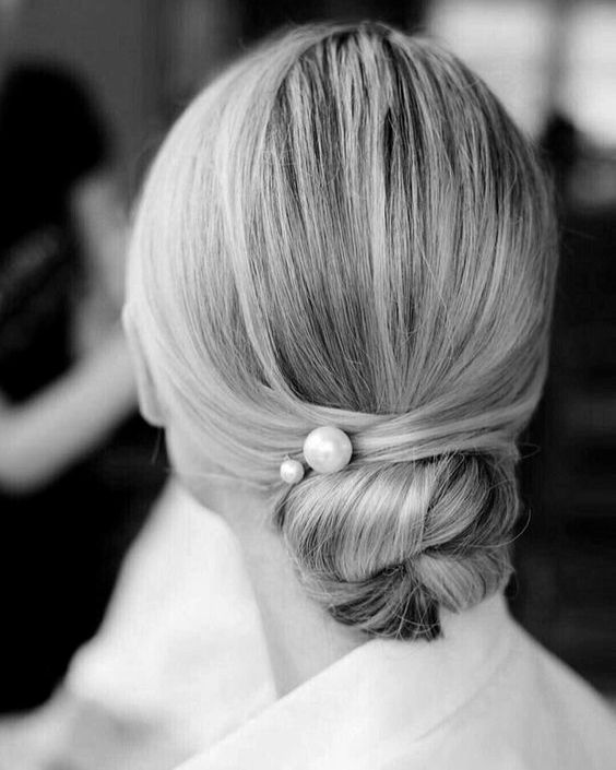 a very sleek twisted low bun with no hairpieces for a chic ultra-minimalist bridal look