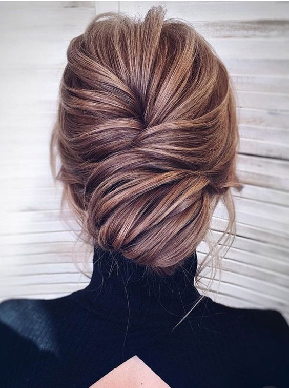 a boho messy wavy low bun with a large side braid and some locks down will perfectly finish off your boho chic look