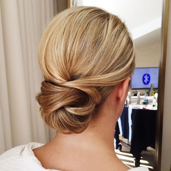 a low twisted very tight chignon guarantees a picture-perfect look for the whole day
