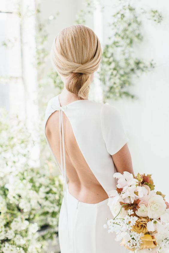 a perfect sleek knotted low bun is eye-catchy yet very simple and is ideal for a minimalist bride