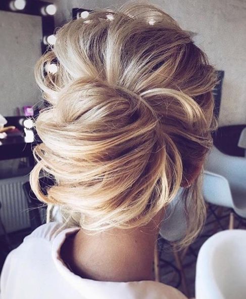 a messy curly low side bun with some curls down is a great idea for an effortlessly chic look