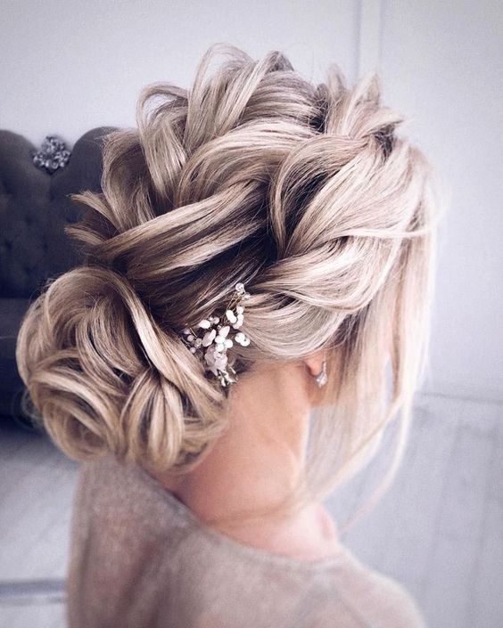 a cool braided low updo with a texture looks cool for a rustic or boho bride