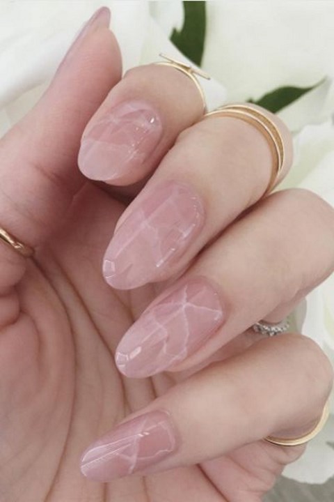 peachy pink nails and white ones with a single chevron accent for a cheerful summer feel in your look