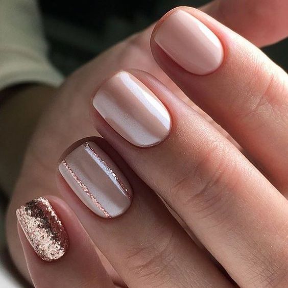 blush almond nails with silver glitter triangles as accent for a cute touch