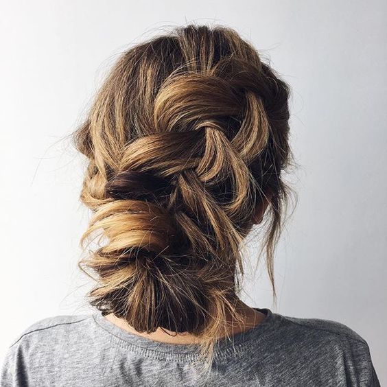 messy wavy braided half updo with fresh foliage is great for a boho or modern bride