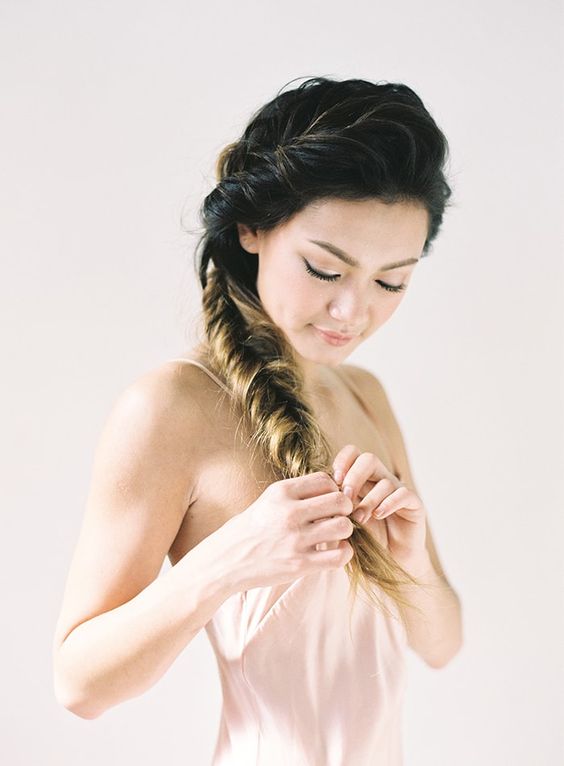 short wavy hair with a large braid on top is useful for a casual or boho wedding