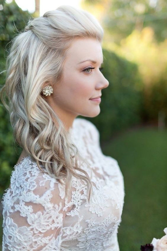 a braided half updo with light waves on long hair is a great idea for many bridal styles