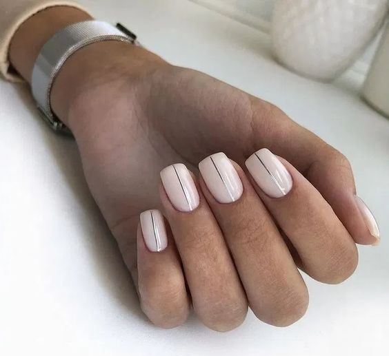 matte white nails and two accent nails done with silver leaf for a slight glam and shiny touch
