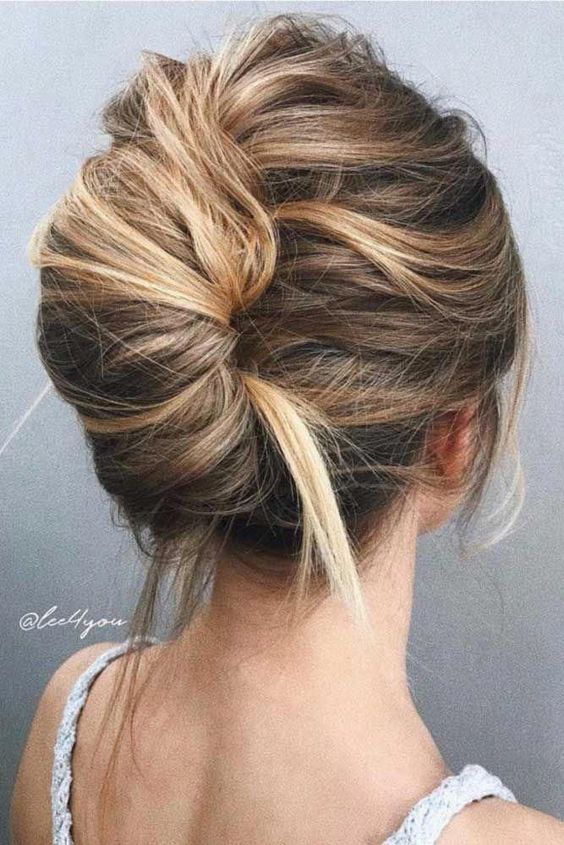 a super elegant and sleek French twist updo with a swirl, a volume and a sleek chignon will fit a formal wedding