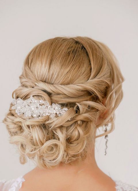 messy curled updo wwith a chic vintage jewel