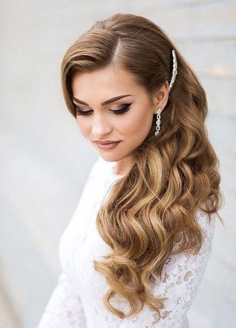side swept curls and a headpiece to keep them in place