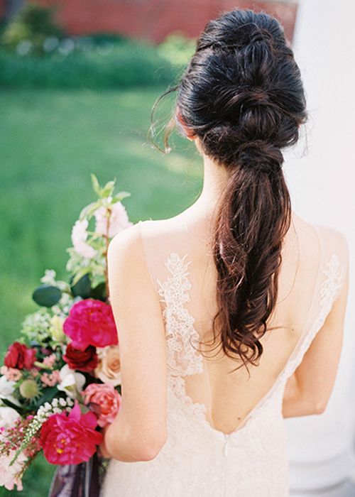 long twisted braid with greenery and berries tucked in for a boho or woodland bride