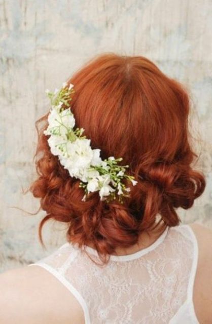 elegant twisted and curly wedidng updo with peach-colored blooms