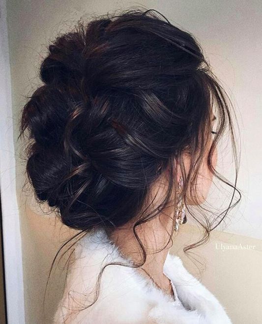 braided messy updo with a flower hairpiece will be great for boho brides
