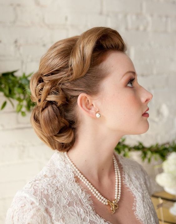 a retro updo with messy waves and some locks down plus a very shiny star hairpiece