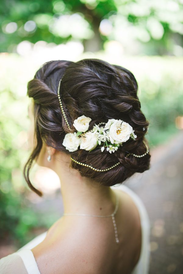 a vintage-inspired low updo with a volume on top and a sleek top plus a wavy lower part