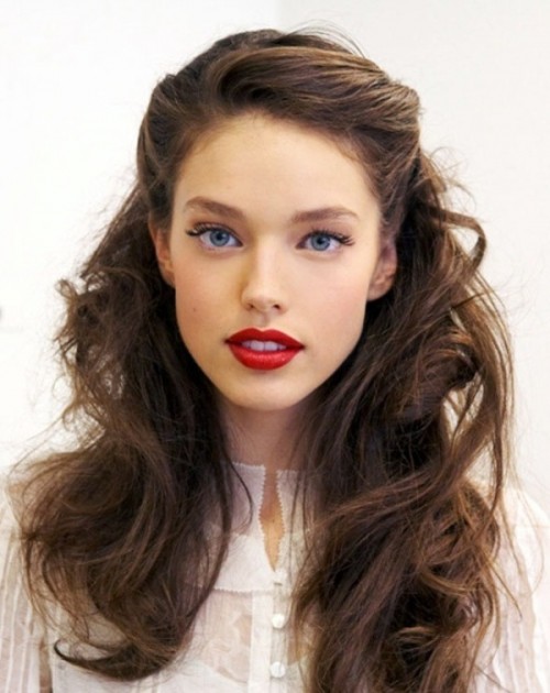a low updo accented with vintage waves that frame the face looks very chic and very elegant