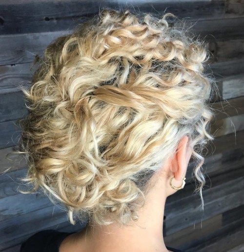 a messy twisted low updo with curls and bangs is a very romantic option, which fits many bridal styles