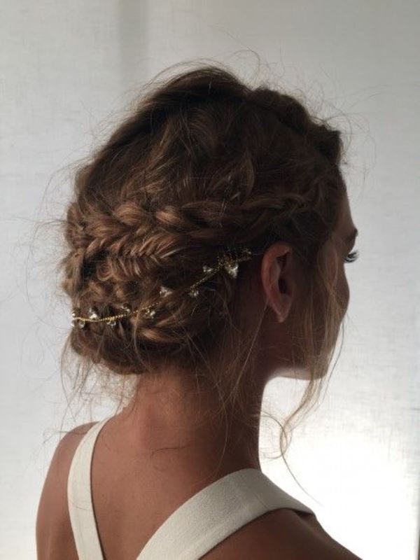 a curly double braided low bun is great for many bridal styles, from more romantic to boho ones