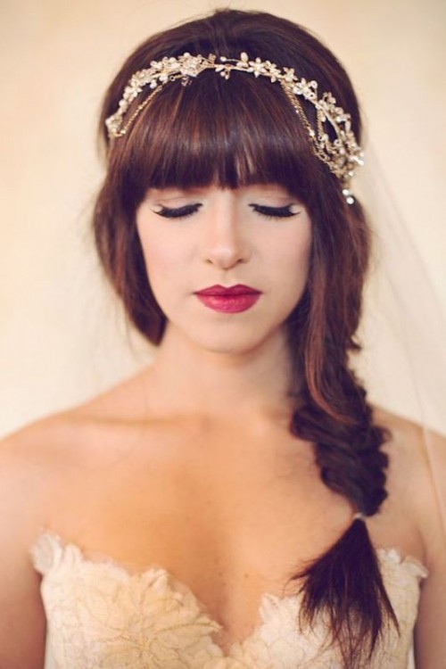 a messy high ponytail with bangs is a perfect fit for a modern or casual bride