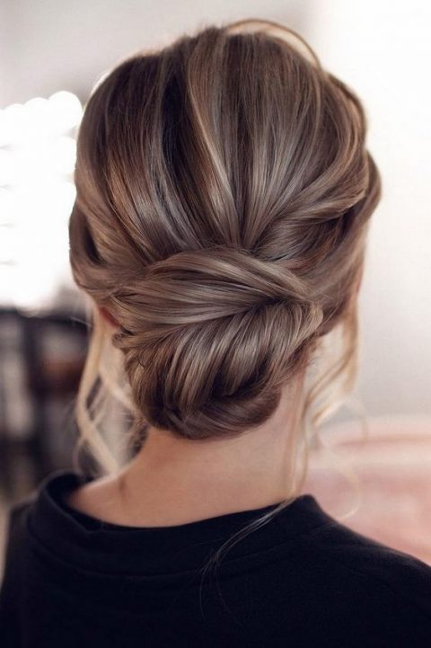 a chic wedding updo with a dimensional bump and twists will keep you picture-perfect during the whole day