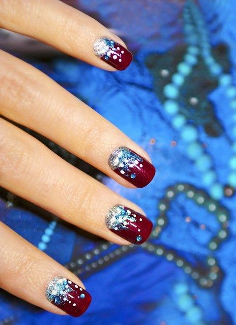 a French manicure with silver glitter and blue snowflakes plus silver patterns for a snow-loving bride