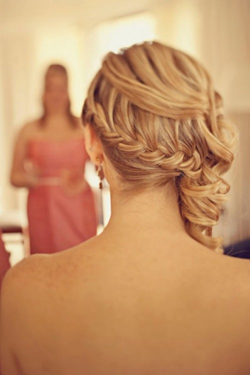 an elegant top knot with a braid that surrounds and highlights it looks super chic and elegant