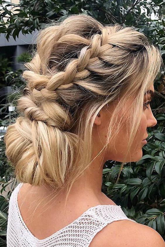 a messy low updo with a double fishtail braid and some hair down is a romantic idea