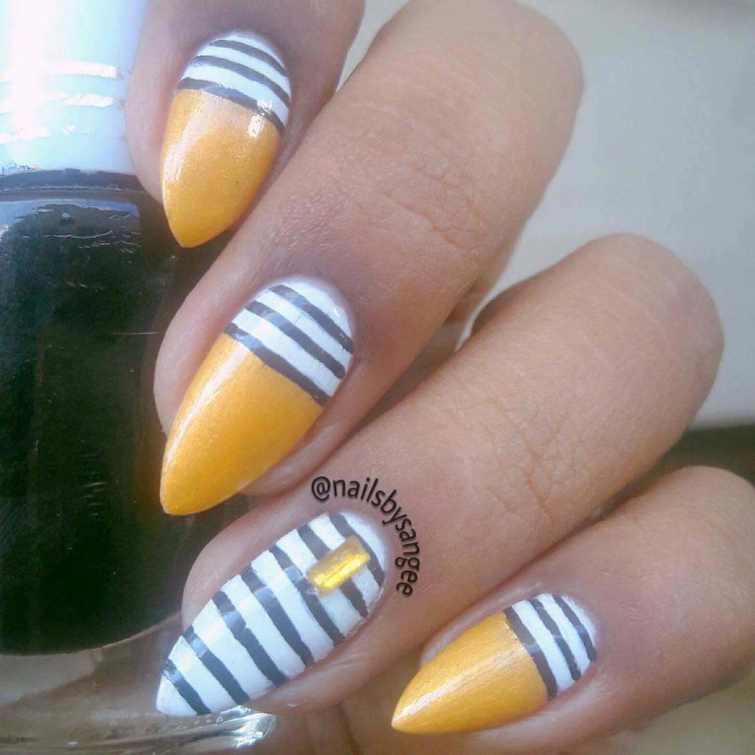 Elegant Golden Nails with Black and White Design