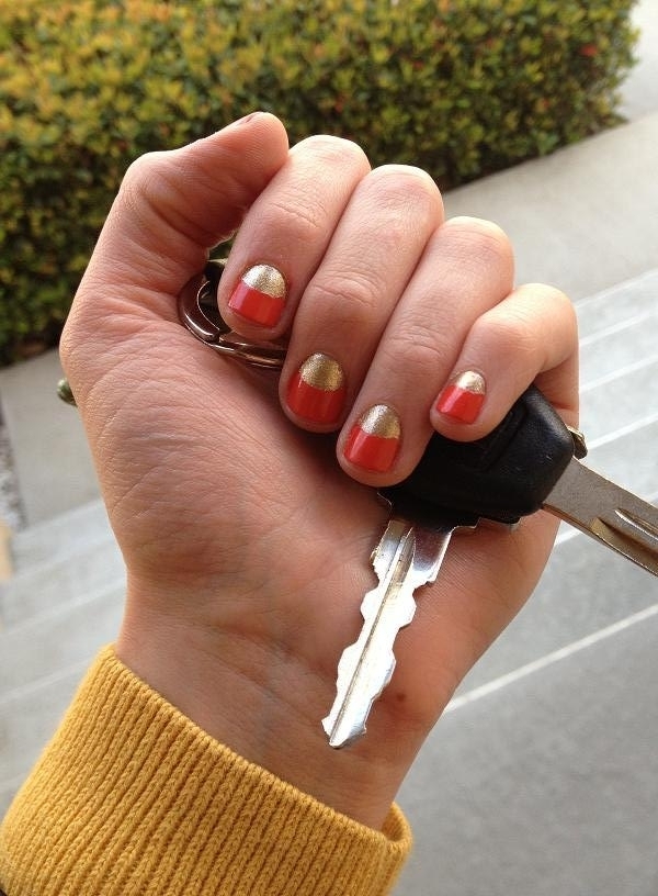 Orange nails with gold nail beds