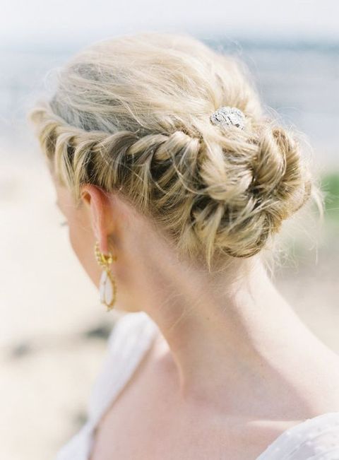 a top knot with several thin braids and a fringe